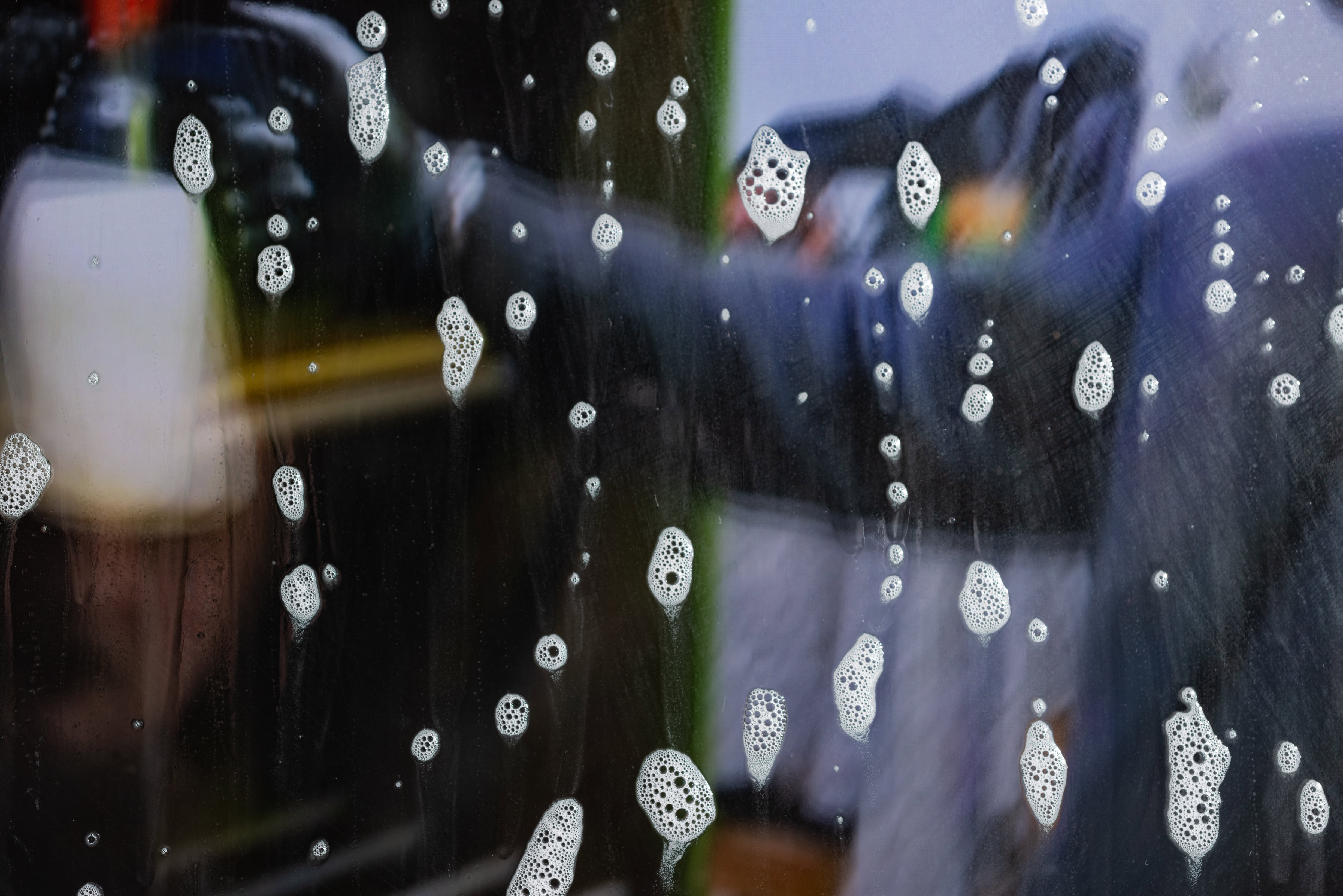 close up picture of soap bubbles on a window